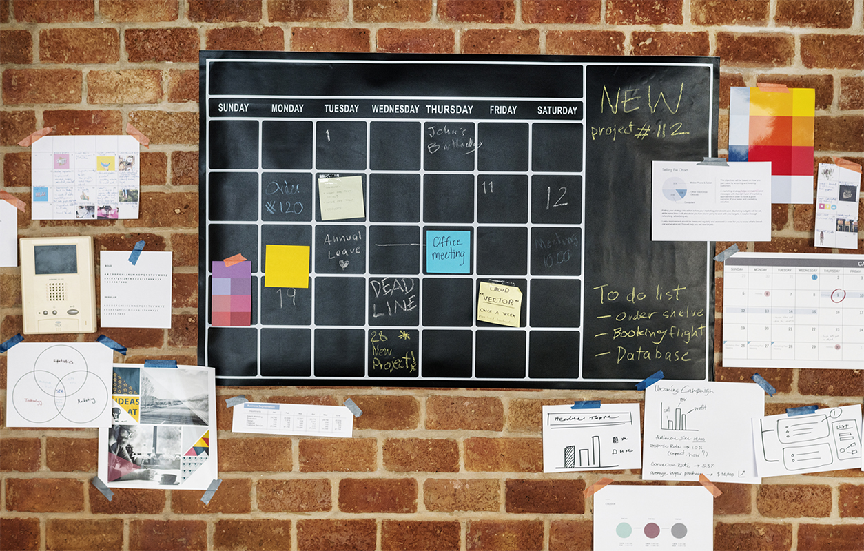 Project planner on brick wall